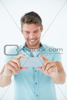 Happy young man looking at his mobile phone