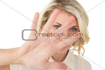 Portrait of young woman signals stop