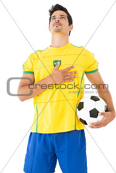 Brazilian football player listening to anthem