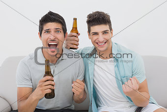Excited soccer fans watching tv