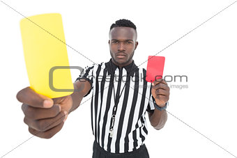 Serious referee showing yellow and red card
