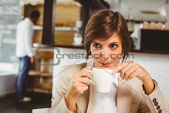 Pretty businesswoman enjoying her coffee