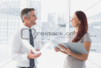 Business people smiling and talking