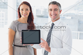 Business people holding up tablet