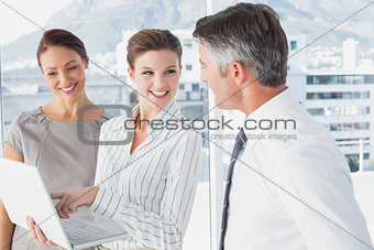 Businesswoman using laptop at work