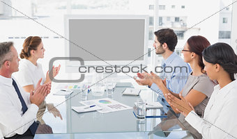 Business colleagues watching video presentation
