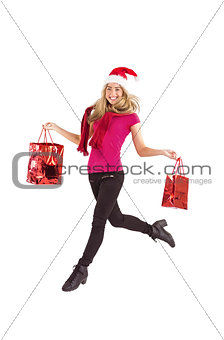 Festive blonde carrying gift bags
