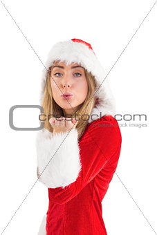 Pretty santa girl blowing over hand