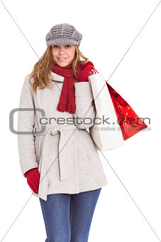 Happy blonde in winter clothes with bags