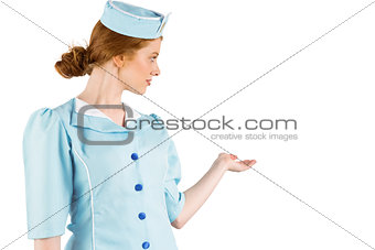 Pretty air hostess presenting with hand