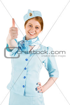 Pretty air hostess with hand on hip