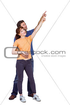 Happy couple pointing upwards together