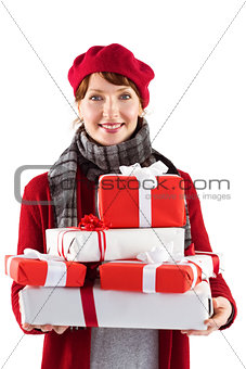 Smiling woman holding large presents