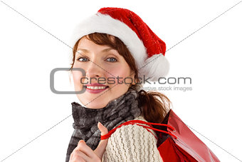 Smiling woman wearing santa hat