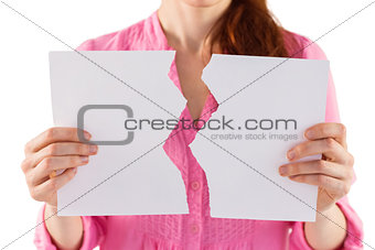 Woman holding torn sheet of paper