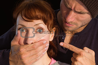 Man grabbing woman around mouth