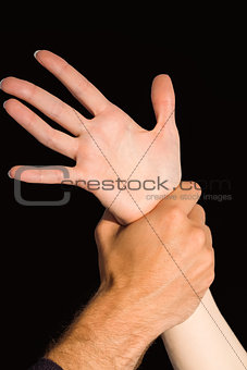 Womans wrist held by man