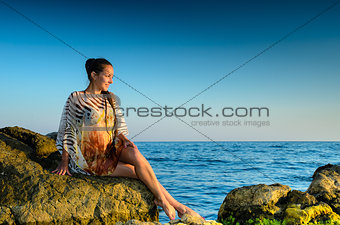 Young woman  on a rock