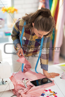 Tailor woman using tablet pc at work