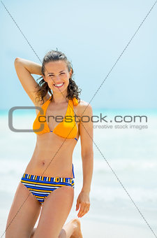 Portrait of happy young woman on sea shore