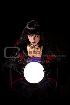Beautiful witch or fortune teller with a crystal ball 