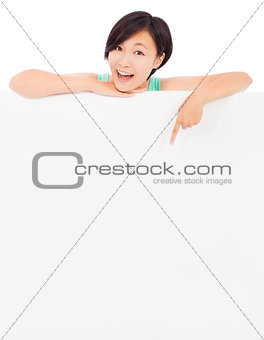 happy young girl point to empty blackboard