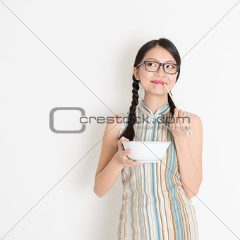 Asian Chinese woman eating