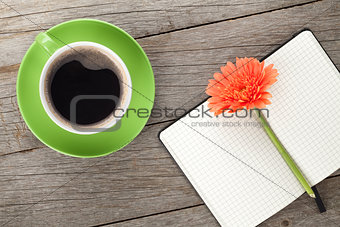 Blank notepad, coffee cup and orange gerbera flowers