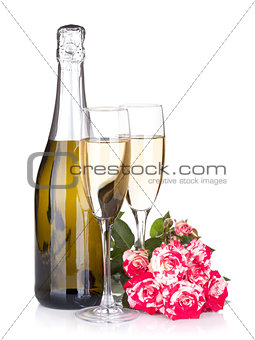 Champagne bottle, two glasses and red rose flowers
