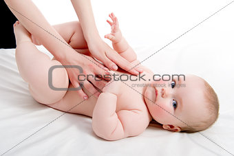 Mother massaging her lovely baby