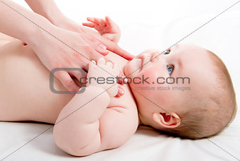 Mother massaging her lovely baby