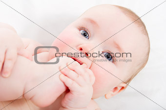 Adorable baby sucking his toe
