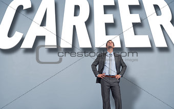 Composite image of smiling businessman with hands on hips