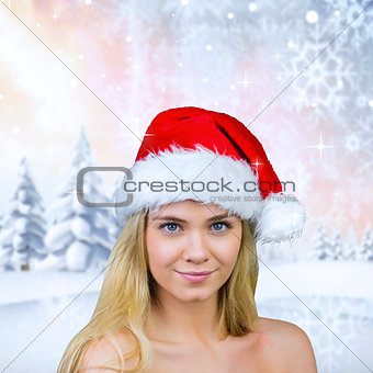 Composite image of blonde with bare shoulders in santa hat