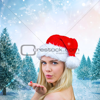 Composite image of blonde with bare shoulders in santa hat
