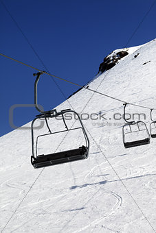 Chair-lift in ski resort at sun day