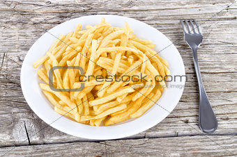 French fries closeup over wood
