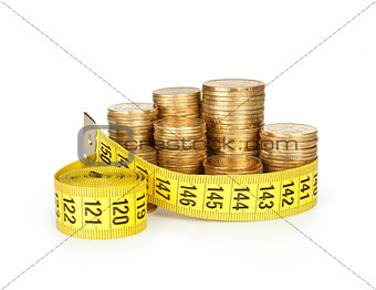 stack of coins with tape measuring isolated on white, selective focus and money concept.