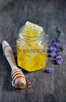 honeycomb and honey in glass jars 