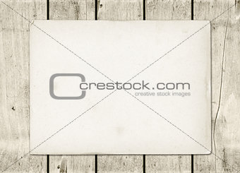 Blank vintage paper sheet on a white wood board