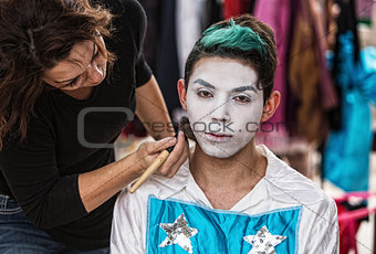 Woman Brushing Makeup on Clown