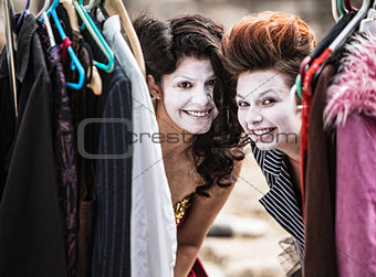 Clowns Peeking from Clothes Rack