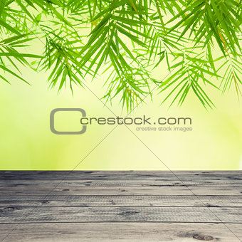 Empty wooden table and bamboo leaves