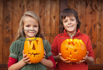 Kids with Halloween pumpkin jack-o-lanterns