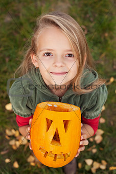 Autumn portrait with a Halloween pumpkin jack-o-lantern