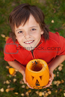 Boy with a Halloween pumpkin jack-o-lantern