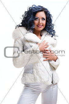 Beautiful brunette in white fur coat