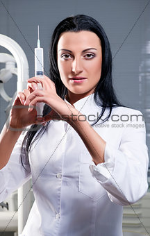 Attractive woman with medical syringe