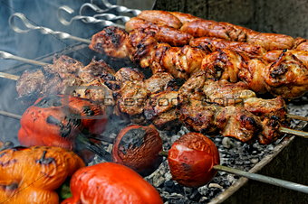 Grilled sausages, meat and vegetables on barbecue