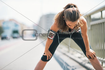Portrait of tired fitness young woman catching breathe